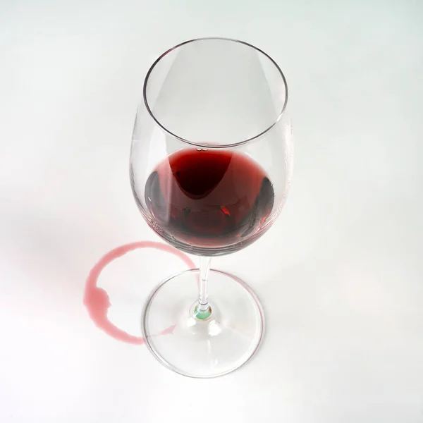 the imprint of red wine left by a glass on a white surface
