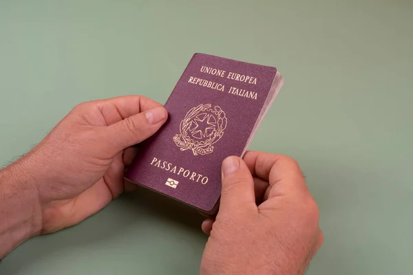 a man with an Italian passport in the hands