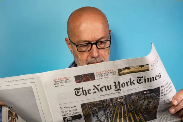 Vienna, Austria. September 2022.  a man reading the New York Times newspaper