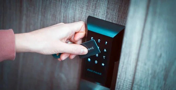 Girl opens a door with a smart security system. — 스톡 사진