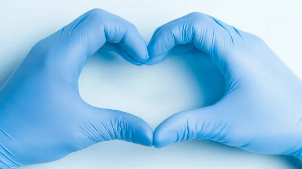 Doctors hands show the symbol of heart.