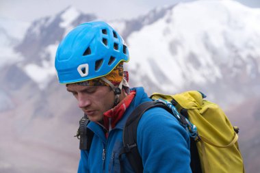 Portrait of a climbing man in a helmet.