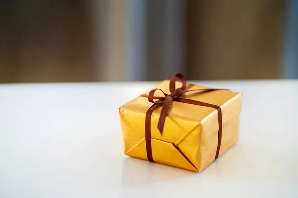 Cute Little Gift Golden Wrapper Ribbon Lies Table Beautiful Surprise — 图库照片