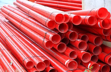 İnşaat alanındaki kırmızı fiberglas borular, endüstriyel uygulamalarda kullanılan aşınmaya dayanıklı fiberglas kompozit boru..