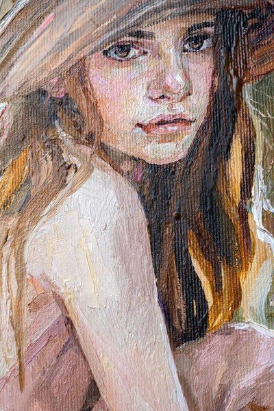 .A woman in a straw hat sits in the sunset.