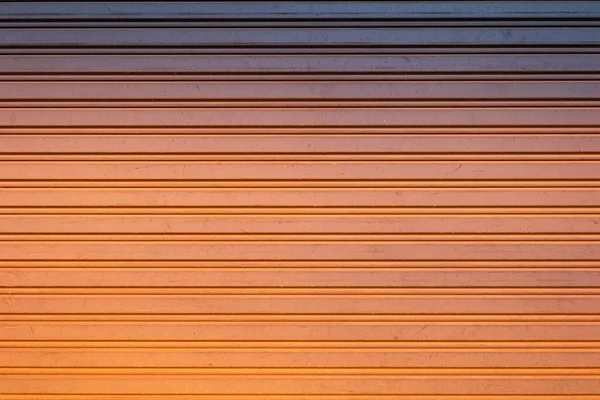 Tło Wzoru Metalowe Drzwi Zewnątrz Budynku Dotyka Nasyconego Pomarańczowego Światła — Zdjęcie stockowe