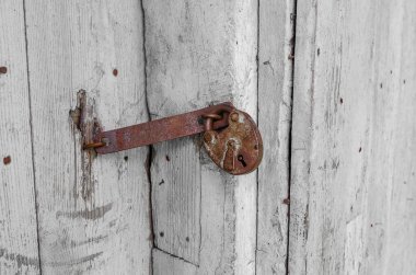 Eski ahşap bir kilisenin ahşap kapısı. Paslı kilit asılıyor