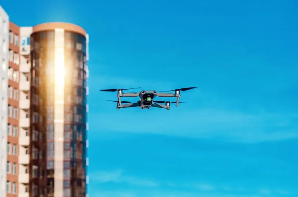 Drone flies in air in city. New technologies.