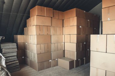 Cardboard boxes stacked in warehouse. Boxes with goods prepared for shipment.