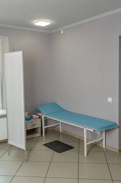 Modern room in clinic for examination and treatment of patients. Medical couch.