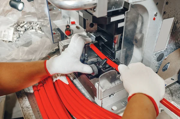 Hands of  master in gloves near machine. Production equipment at  modern plant.