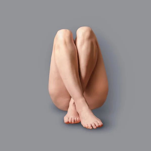Female legs crossed. front view on beautiful naked female legs and pelvis