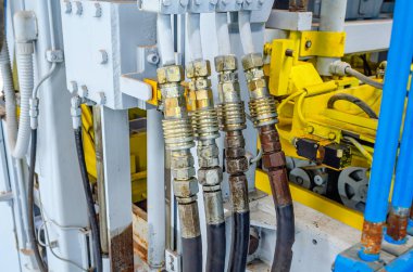 Üretim ekipmanının parçası. Hortumlar, borular. Kaldırım taşları üretmek için kullanılan makinenin bir parçası. Yakın plan..