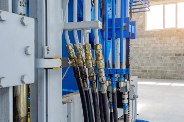 Boruların bağlantısı. Üretim ekipmanının parçası. Hortumlar, borular. Kaldırım taşları üretmek için kullanılan makinenin bir parçası. Yakın plan..