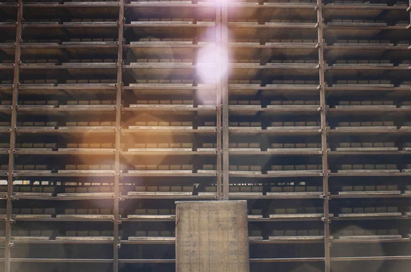 Shelving with cobblestones. Warehouse at  factory. Production of paving slabs. Sun glare