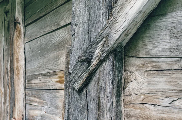 Old wooden barn wall. Side view of wooden wall in weathered wooden style. Wooden nails.