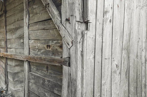 Side view of wooden wall in weathered wooden style. Old wooden barn wall. Wooden nails.