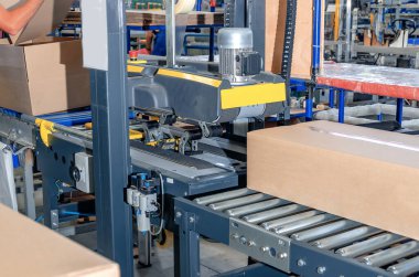 Cardboard packaging machine. Production line of packaging. Industry