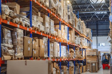 Modern interior of warehouse of finished products. Cardboard boxes on shelves.