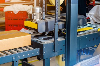 Cardboard packaging machine. Production line of packaging. Industry