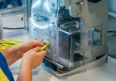 View of employee's hands in production. Production of street lanterns.