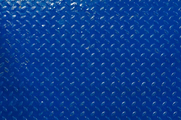 Abstract background pattern on metal. Blue metallic patterned background