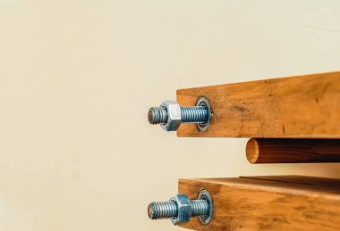 Fastening a bolt nut on wooden bar