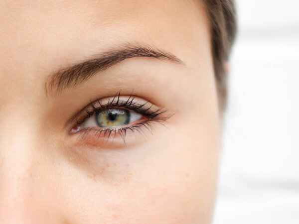 Female eye close-up. Looking into camera