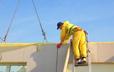 KYIV, UKRAINE - JUNE, 20, 2022:  Builder contractor building frame house wall. Structural Insulated Panels (SIPS) passive house walls construction. 