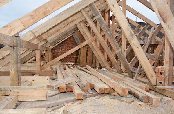 Roofing construction and framing of a new house. Timber trusses, roof framing with a close-up of roof beams, framing, ceiling joists,  struts and rafters.