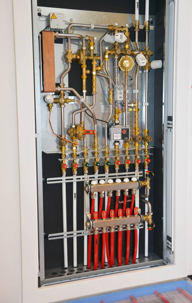 KYIV, UKRAINE - JULY, 21, 2022: Showroom of hydronic hot water radiant floor heating system, connecting floor heating pipes, tubes to the plumbing manifold. Water underfloor heating systems.