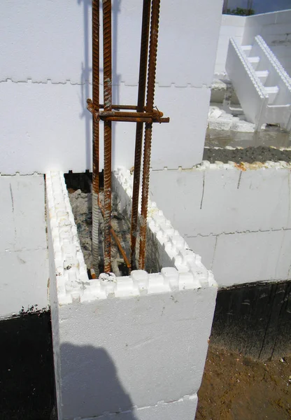 Insulated concrete forms (icf) on house construction. Close up on crowbars with cement concrete in the  Insulated concrete forms. Building ICF energy saving house walls.