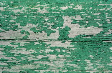Eski ahşap ahşap döşemeli arka planda çatlak ve eski yeşil boya..