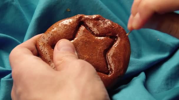 Mens hands scratch brown sugar candy with metal needle pattern in form of star — Stock Video