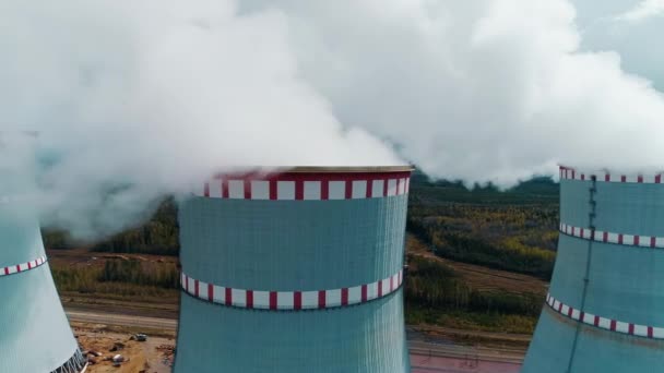 Flying over the smoke-filled cooling tower of a nuclear power plant — Video Stock