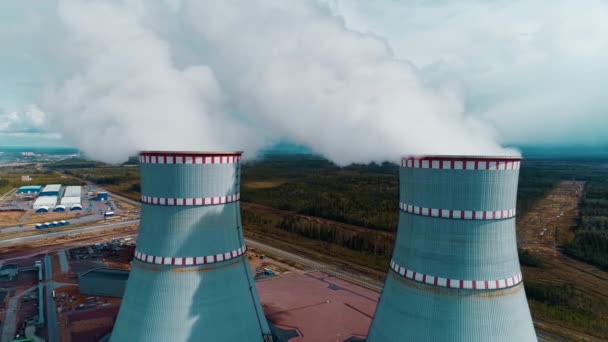 Flying over the smoke-filled cooling tower of a nuclear power plant — Stockvideo