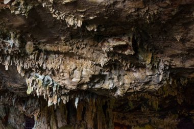 Horizontal view of the ceiling of a salty sea cave, Mediterranean, with a close-up view of the stalagtites.
