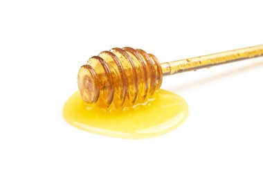 Beyaz arka planda taze bal dökülmüş kaşık. organik vitamin yiyeceği