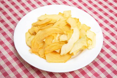 dried pieces of fragrant melon on a plate. vitamin fruit food