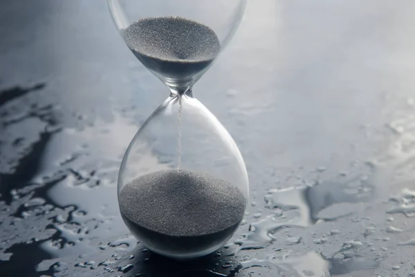 Hourglass on a light background. Time is money. Business solutions in time.