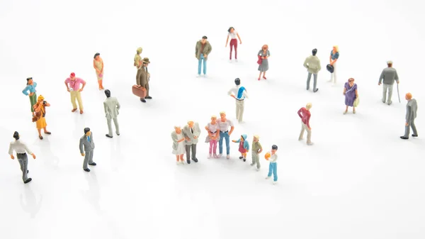 miniature people. different people stand on a white background. communication of society of different generations