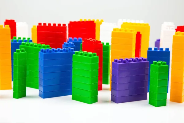 colored blocks of a plastic constructor on a white background in the form of multi-storey buildings. concept of modern buildings and houses