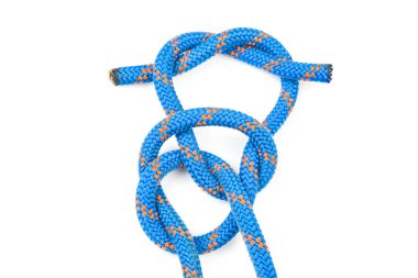 durable colored rope for climbing equipment on a white background. knot of braided cable. item for tourism and travel