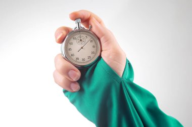 hand with a mechanical analog stopwatch on a white background. Time part precision. Measurement of the speed interval