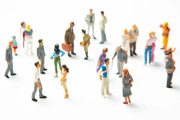 miniature people. different people stand on a white background. communication of society of different generations