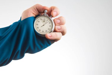 hand with a mechanical stopwatch on a white background. Time part precision. Measurement of the speed interval