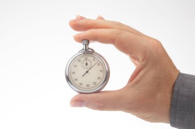 hand with a mechanical analog stopwatch on a white background. Time part precision. Measurement of the speed interval