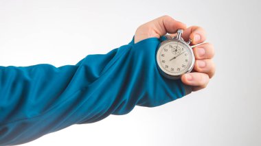 hand with a mechanical stopwatch on a white background. Time part precision. Measurement of the speed interval