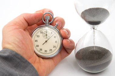mechanical stopwatch and hourglass in hand. Time part precision. Measuring the speed interval with a watch
