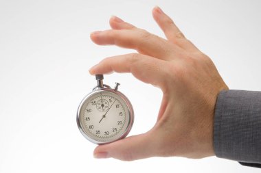 hand with a mechanical analog stopwatch on a white background. Time part precision. Measurement of the speed interval